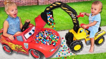 The kids play with cars and colourful balls